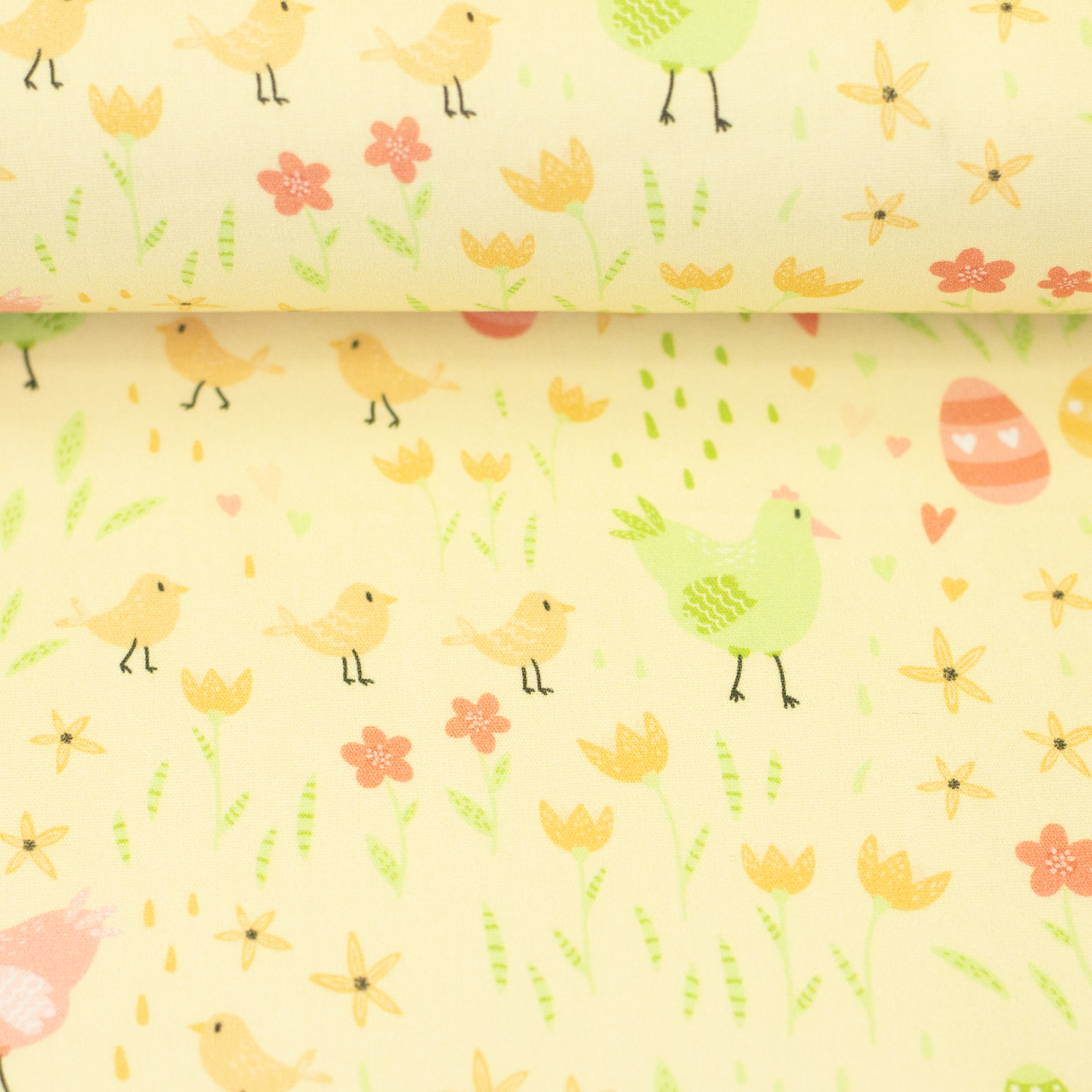 Easter – woven cotton fabric in light yellow, on the fabric bolt
