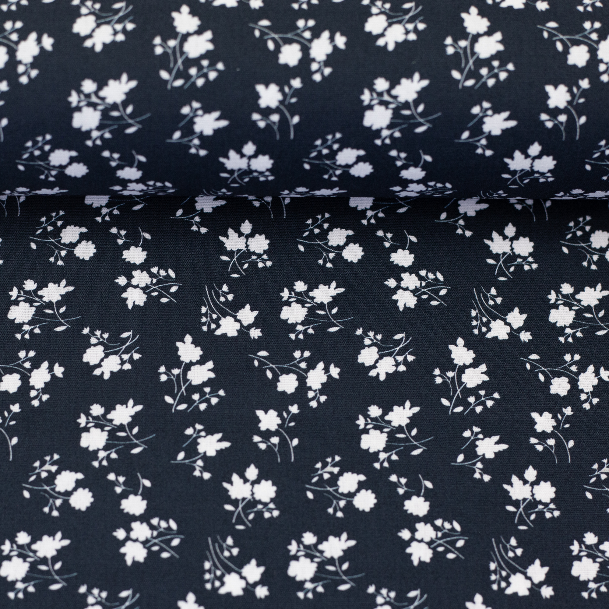 Floralromance – woven cotton fabric in dark blue, on the fabric bolt